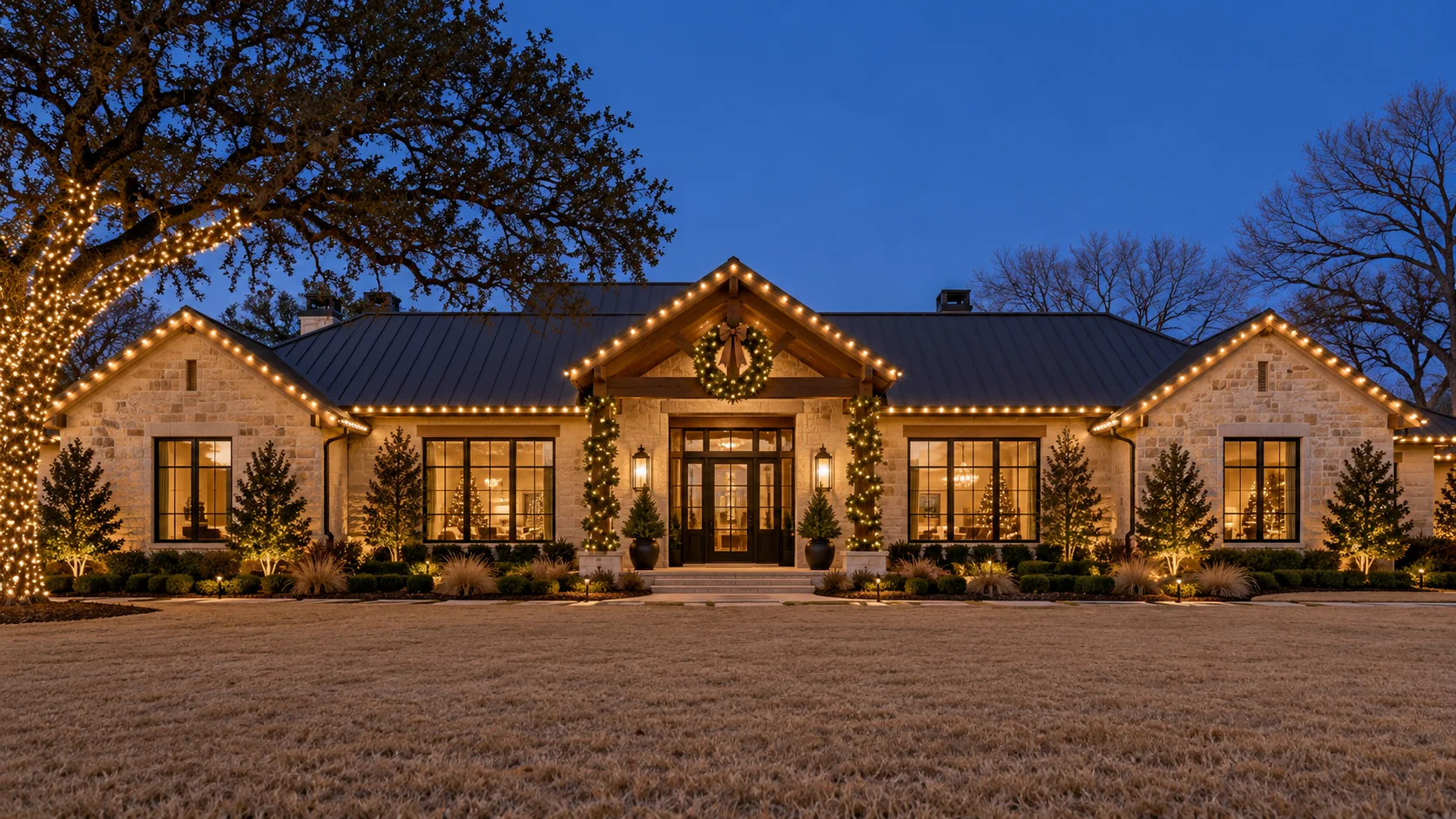 Lighting inspiration: a stone ranch home with warm white rooflines, wreaths and a wrapped tree.